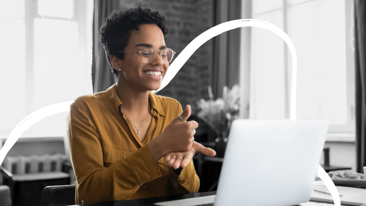 A person recording an intro video at a laptop